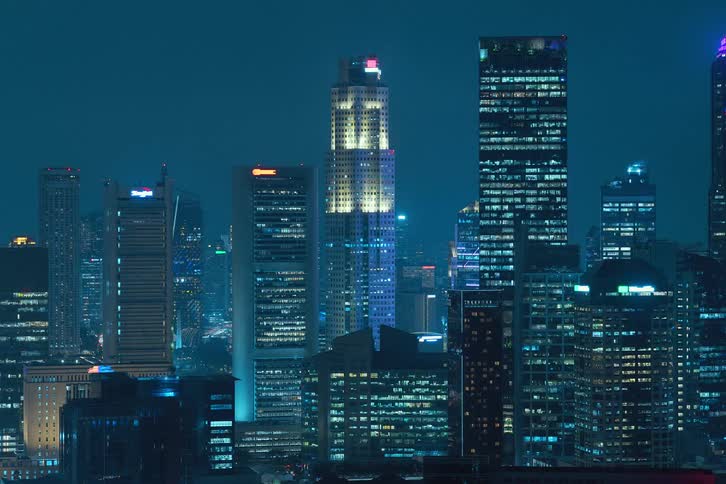 Panoramic view of buildings in a metropolis at night in time lapse
