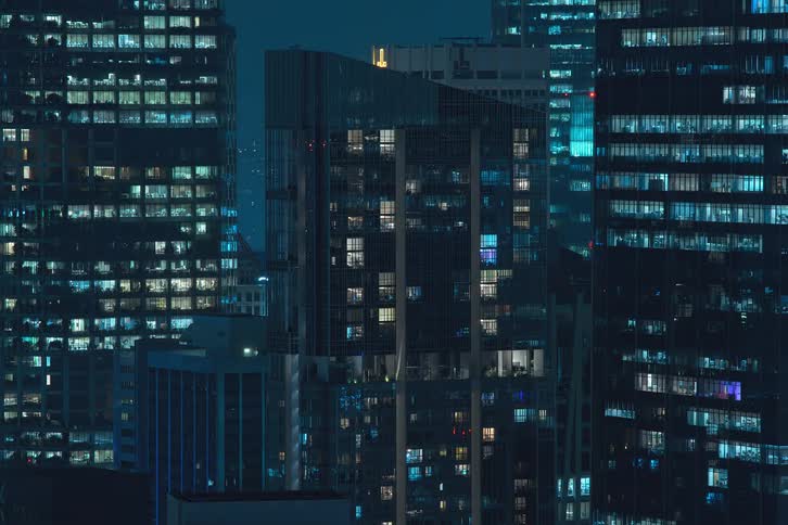 The lights of the citys buildings come on at the same time