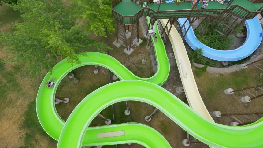 People ride down a waterslide