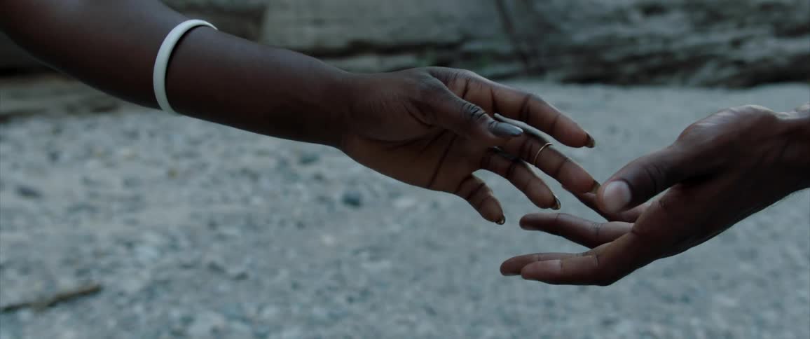 Closeup of two hands of people nearly touching and then pulling back