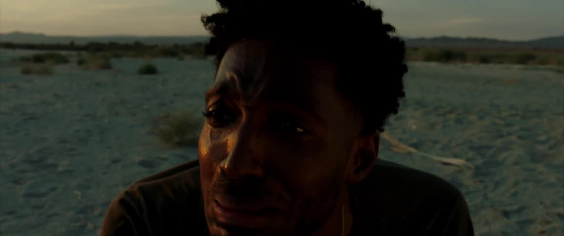 Portrait of a man crying on the beach under a morning sky