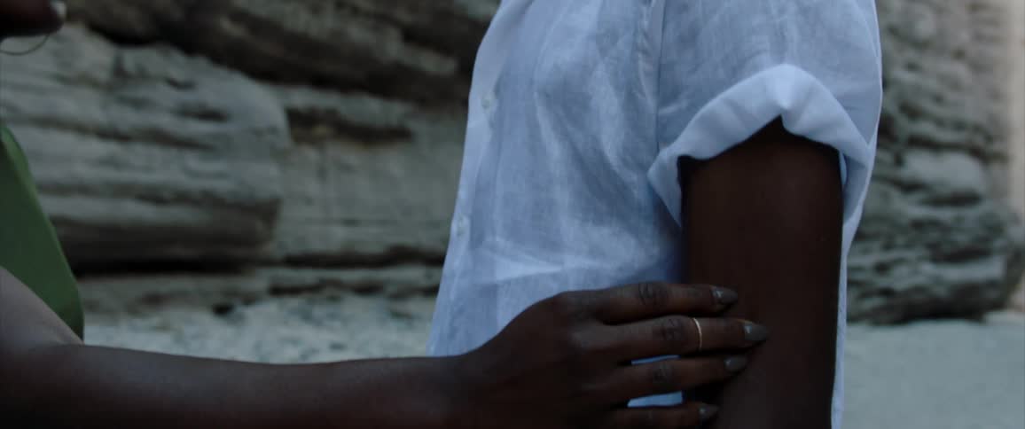 A man and woman touch their arms together