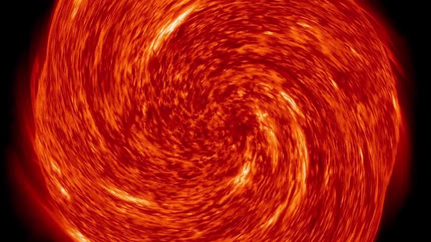Glowing molten orange mass spirals in middle of black surroundings
