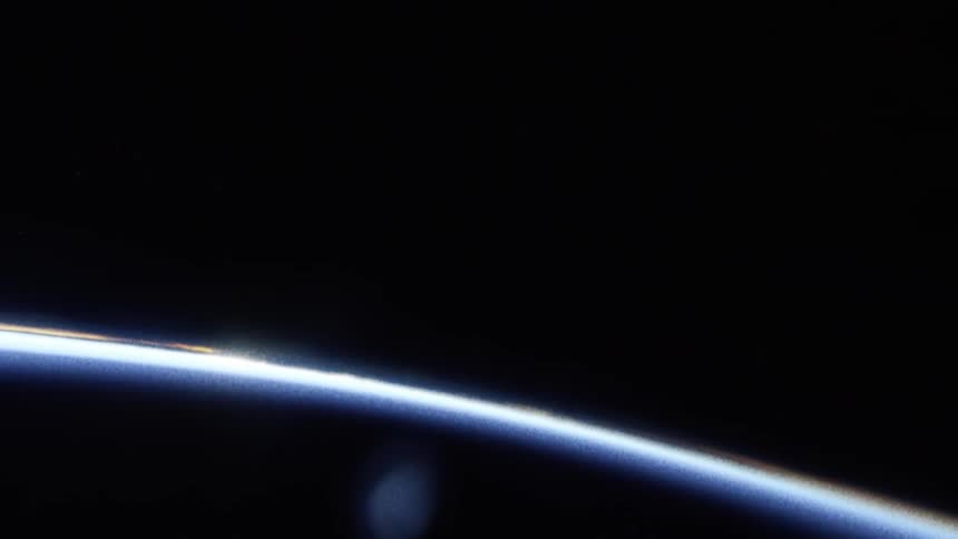 A flare of strong light that is distant behind a circular object