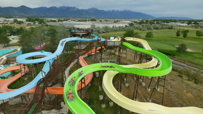 People ride tubes down a waterslide