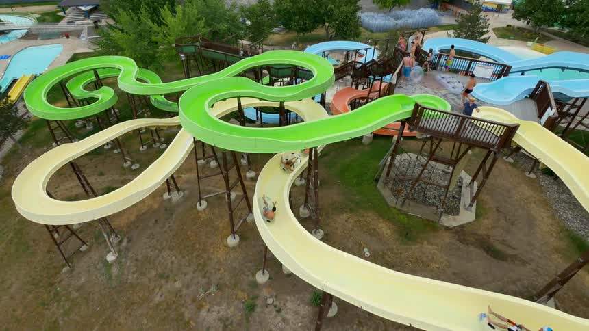 People are riding slides in a water park