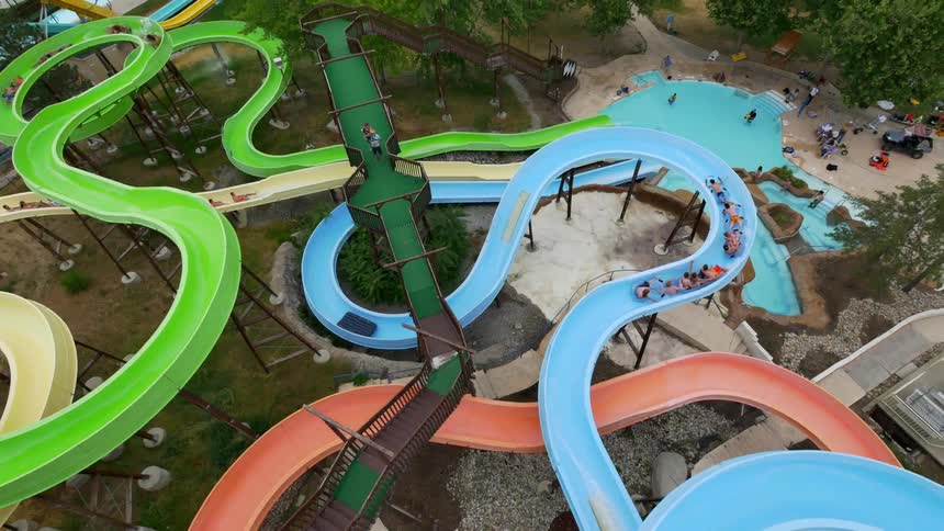 Aerial view of people going down waterslides