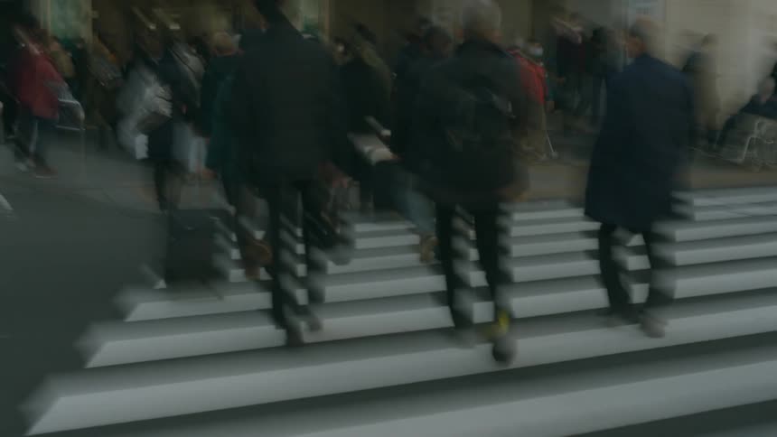People crossing the street at the pedestrian crosswalk