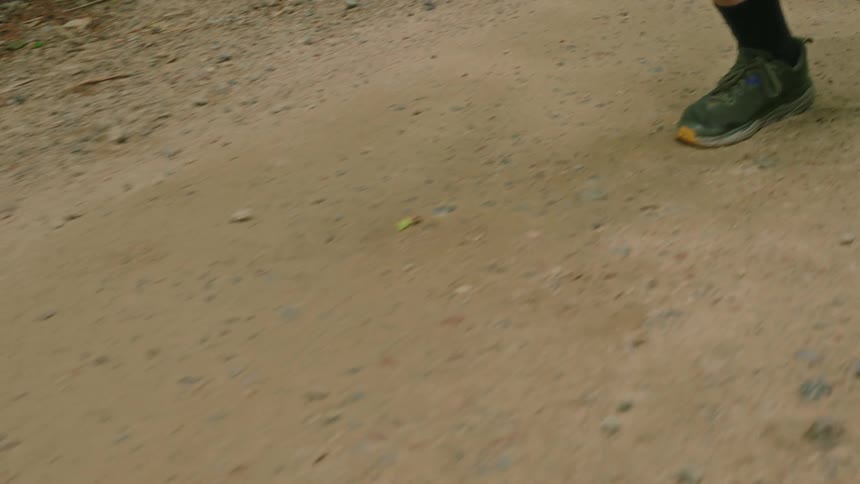 A man runs on a dirt path