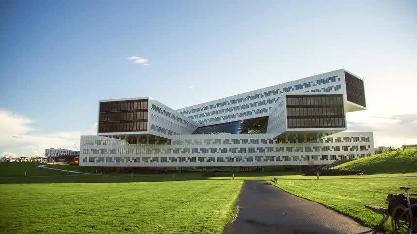 A modern architectural structure on a path with grass on the sides