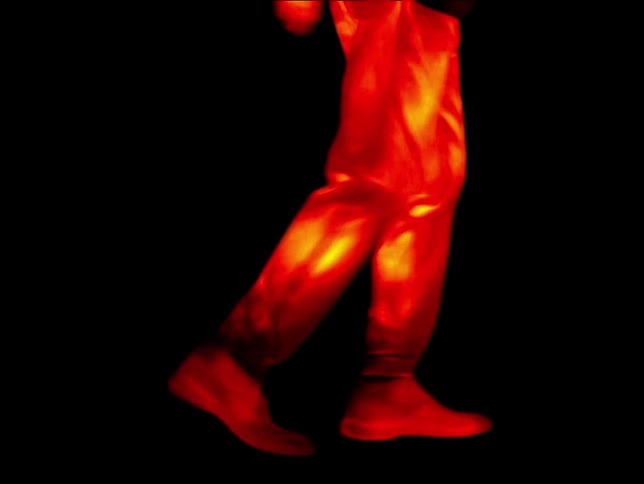 Legs of a person walking simulating waves of body heat