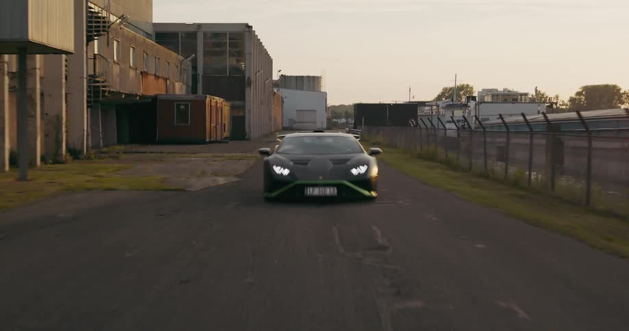 A lamborghini speeding on an asphalt road