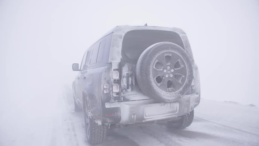 An all terrain vehicle is stopped during a heavy snow storm