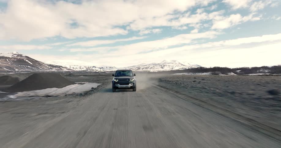 A car drives on the dirt road