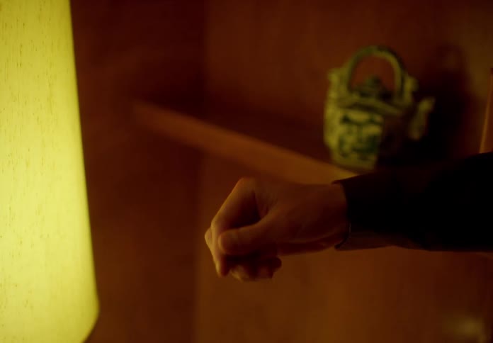 Closeup of a persons hand holding and tossing a coin into the air