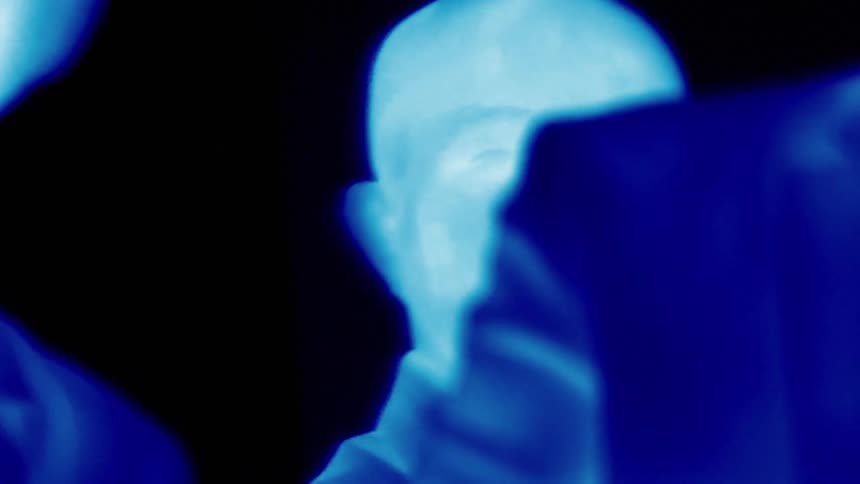 A persons face and the entire image is in shades of blue
