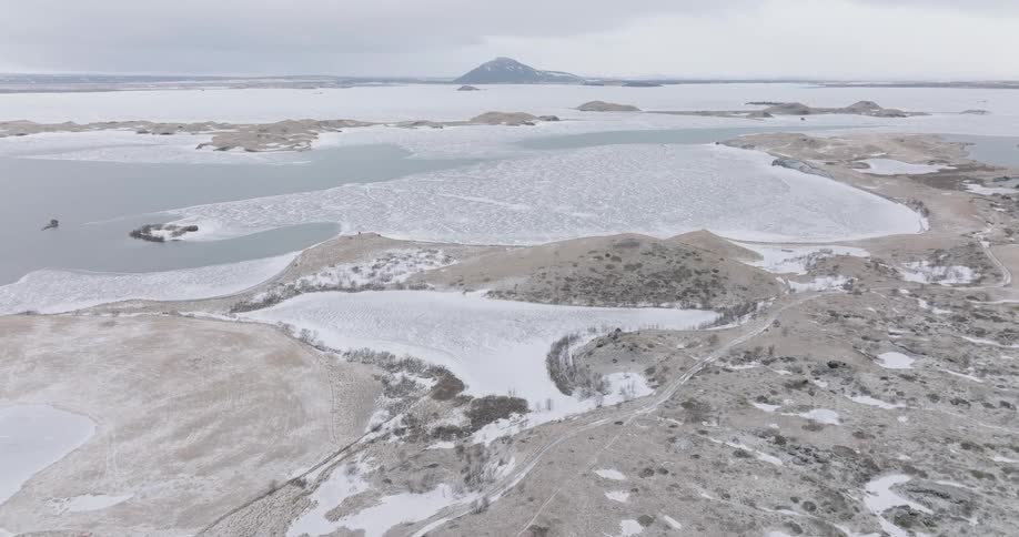 Aerial panorama of a plateau and a sea on a gray sky day