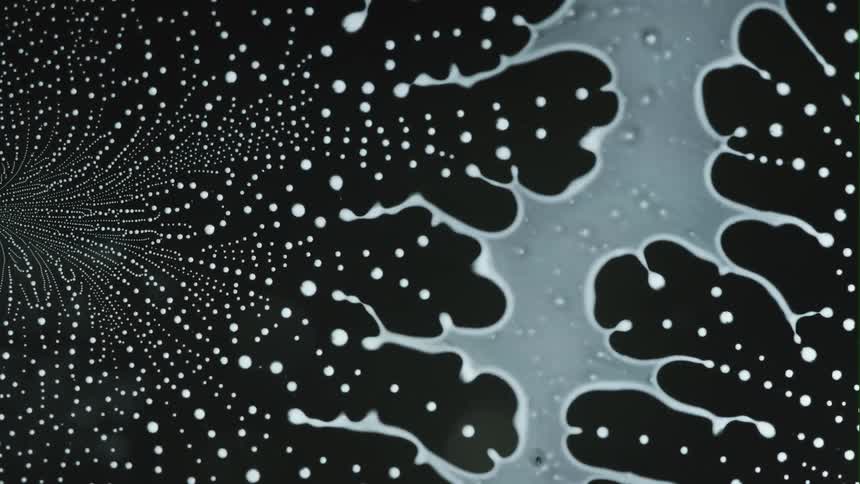 A liquidlike object being stretched and turning into small dots