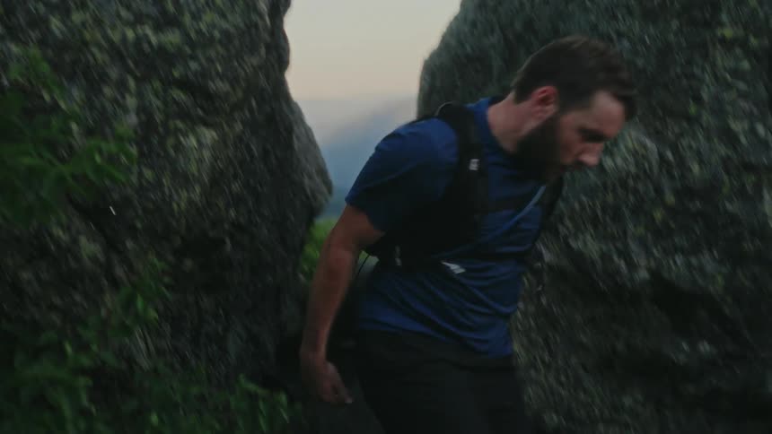 Man crossing through rocks and running through the mountains