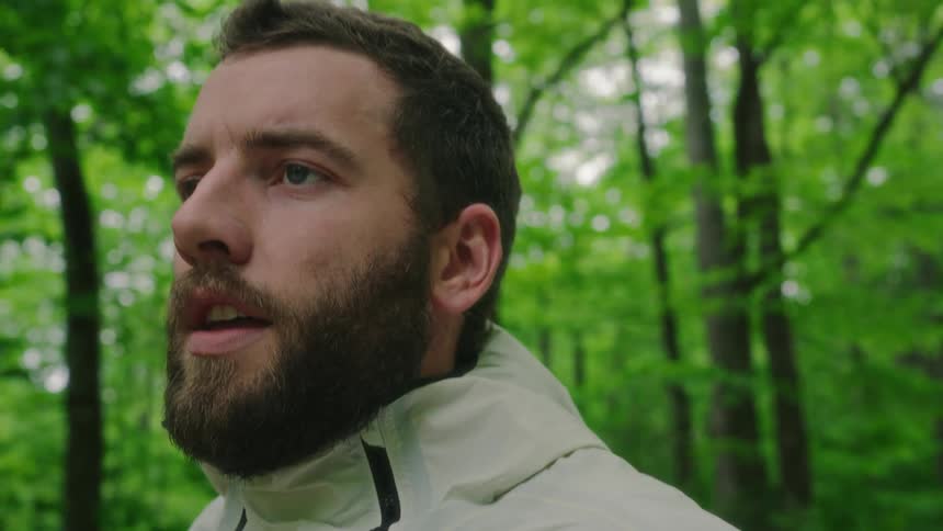A man is running in the woods