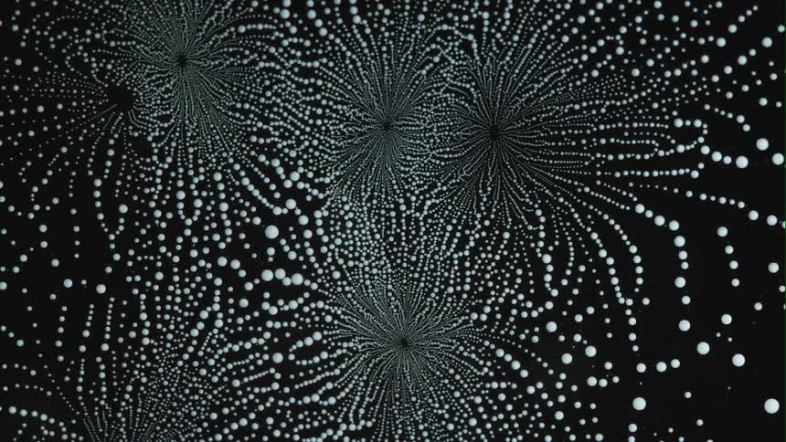 Abstract pattern of white droplets on a black background