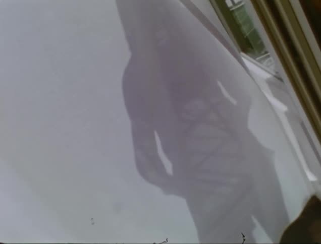 The silhouette of a person on a white curtain sheet