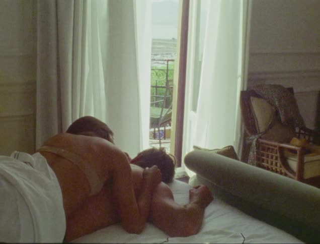 Wizard man in bed without a shirt and with his wife on top and on her back wearing only a bra
