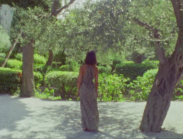 A woman is standing in the park