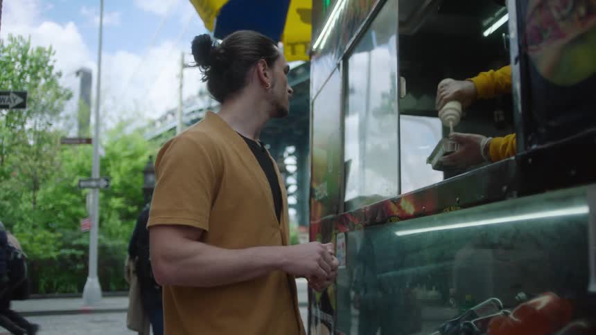 Man waiting for his meal to be ready outside a food truck