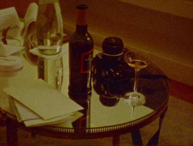 A table filled with drinks glass cup and envelopes