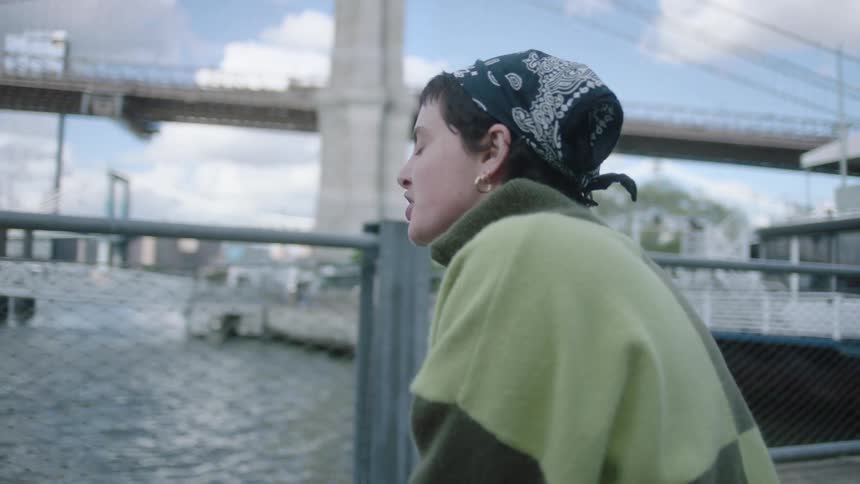A woman talking to someone on the city pier