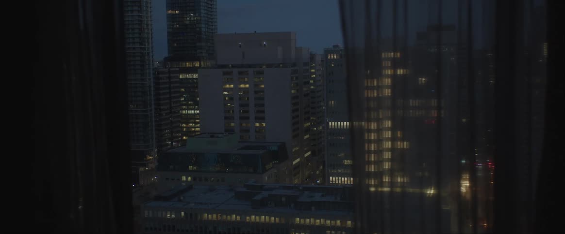 Night view of downtown office buildings from a window across the street