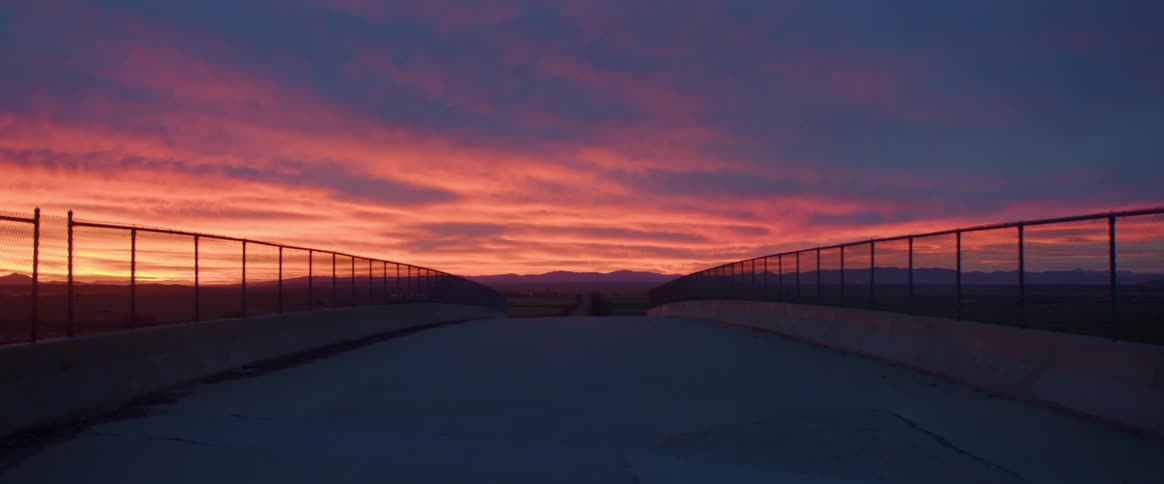 View of a bridge with a reddish sky