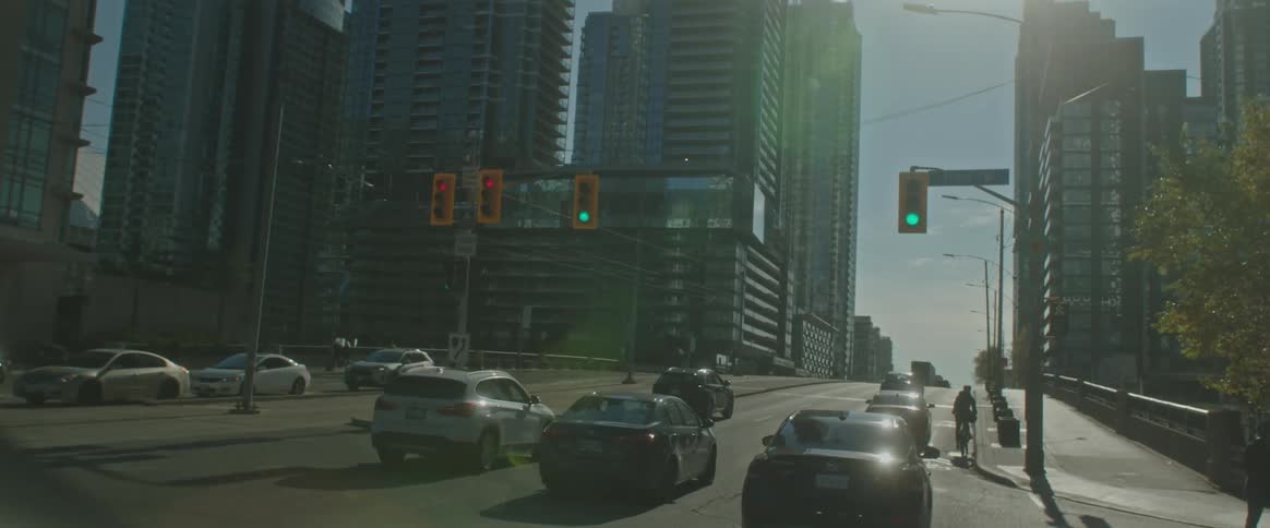 Skyscrapers in the city seen through the windshield of a vehicle