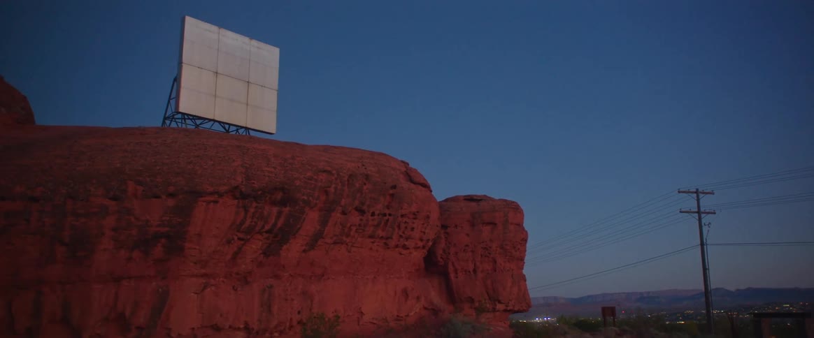 White billboard atop a cliff in the desert
