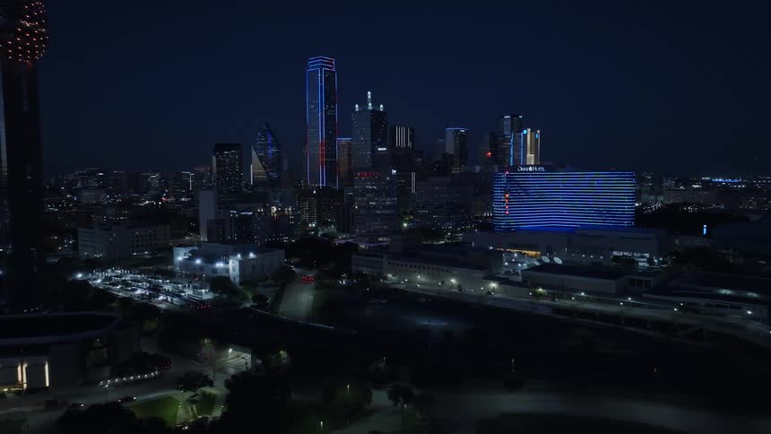 Huge towers with bright lights are in the skyline