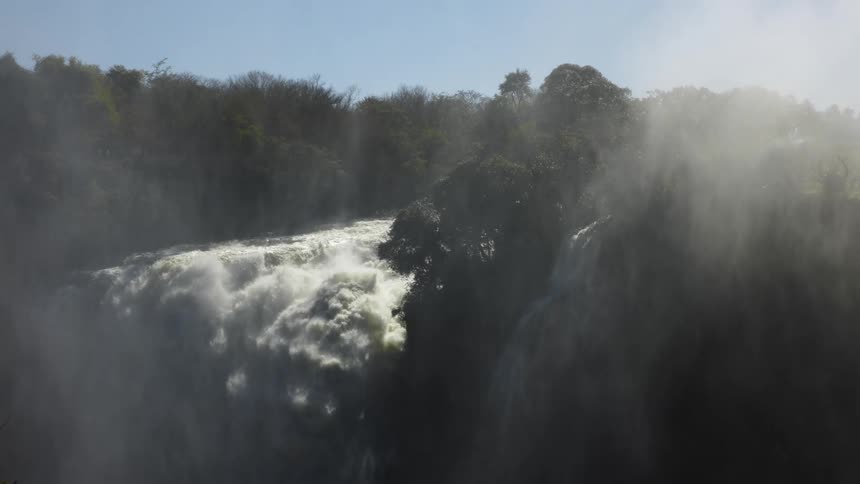 The large waterfall crashes off the cliff