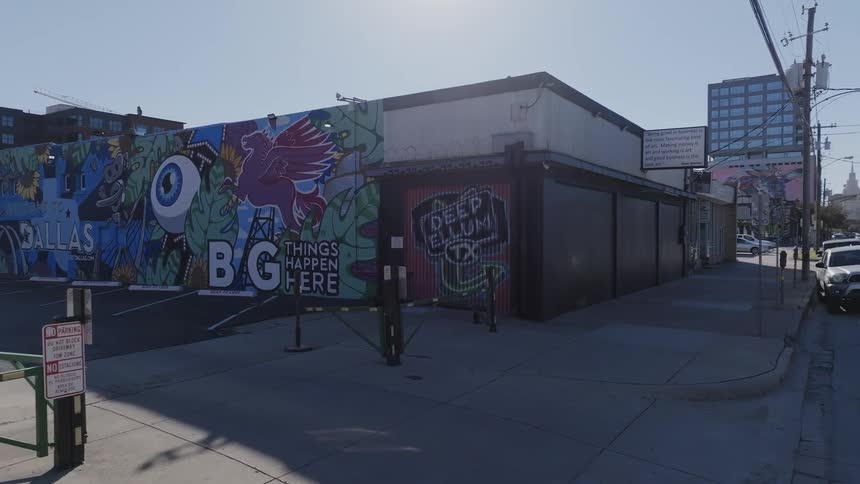 A garage door covered in graffiti in a city