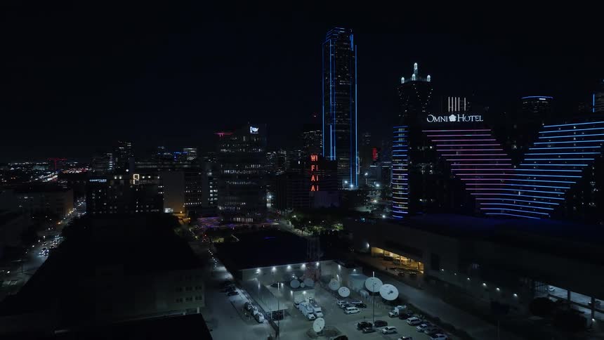 Aerial panorama of a nighttime metropolis with illuminated buildings