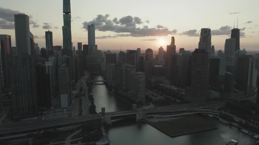 Aerial of metropolitan skyline around a canal at sunrise