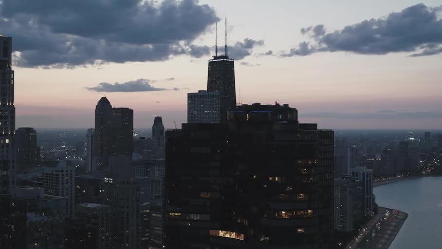 Aerial view of a city skyline dominated by skyscrapers near a river