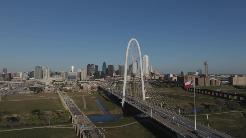 Aerial view of an arch bridge connecting a metropolis