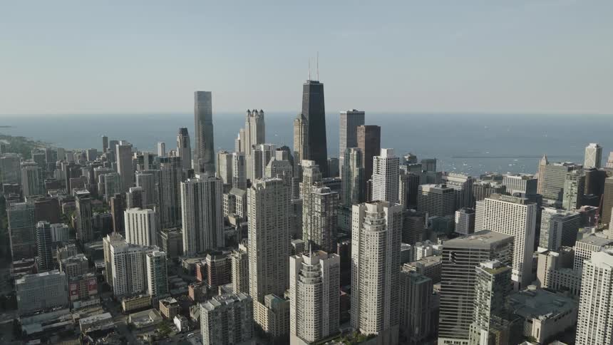 Aerial of downtown skyscrapers with ocean in the background on a summer day