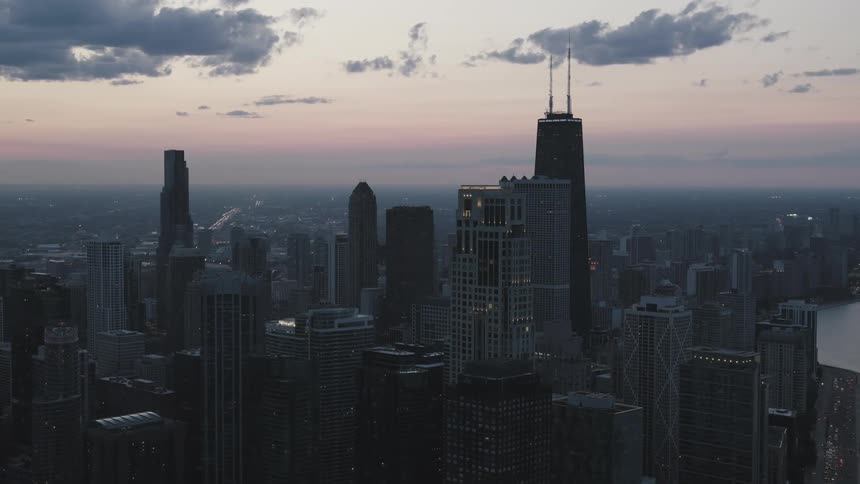 Aerial of skyscrapers in metropolis at dusk