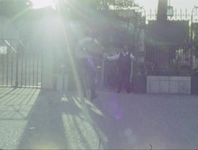 Men greeting each other at the entrance to a property