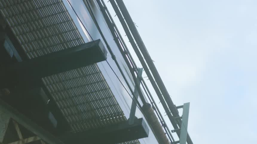 Upward view of a train passing on the tracks on a bridge
