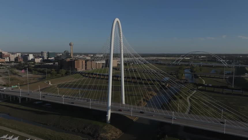 Aerial of an archway bridge in an urban area on a clear sunny day