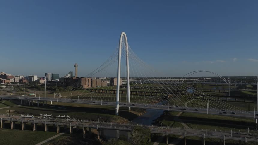 View of a bridge over the river with vehicles moving in daylight