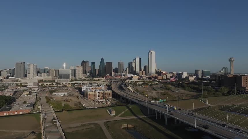 Aerial view of a metropolitan area downtown buildings and a highway bridge