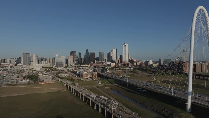 Aerial of urban area and a bridge with an arch on a clear sunny day